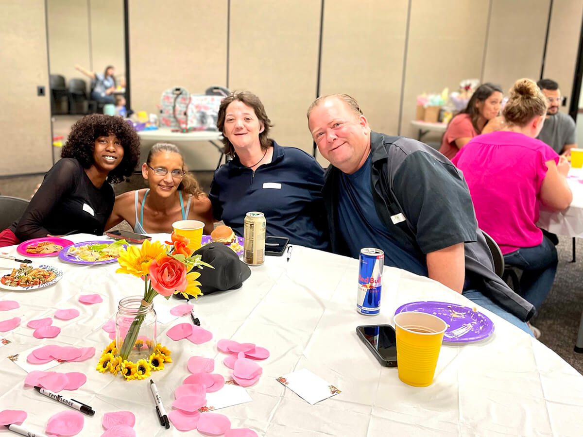 A group of parents pose for a photo at a Better Luncheons event