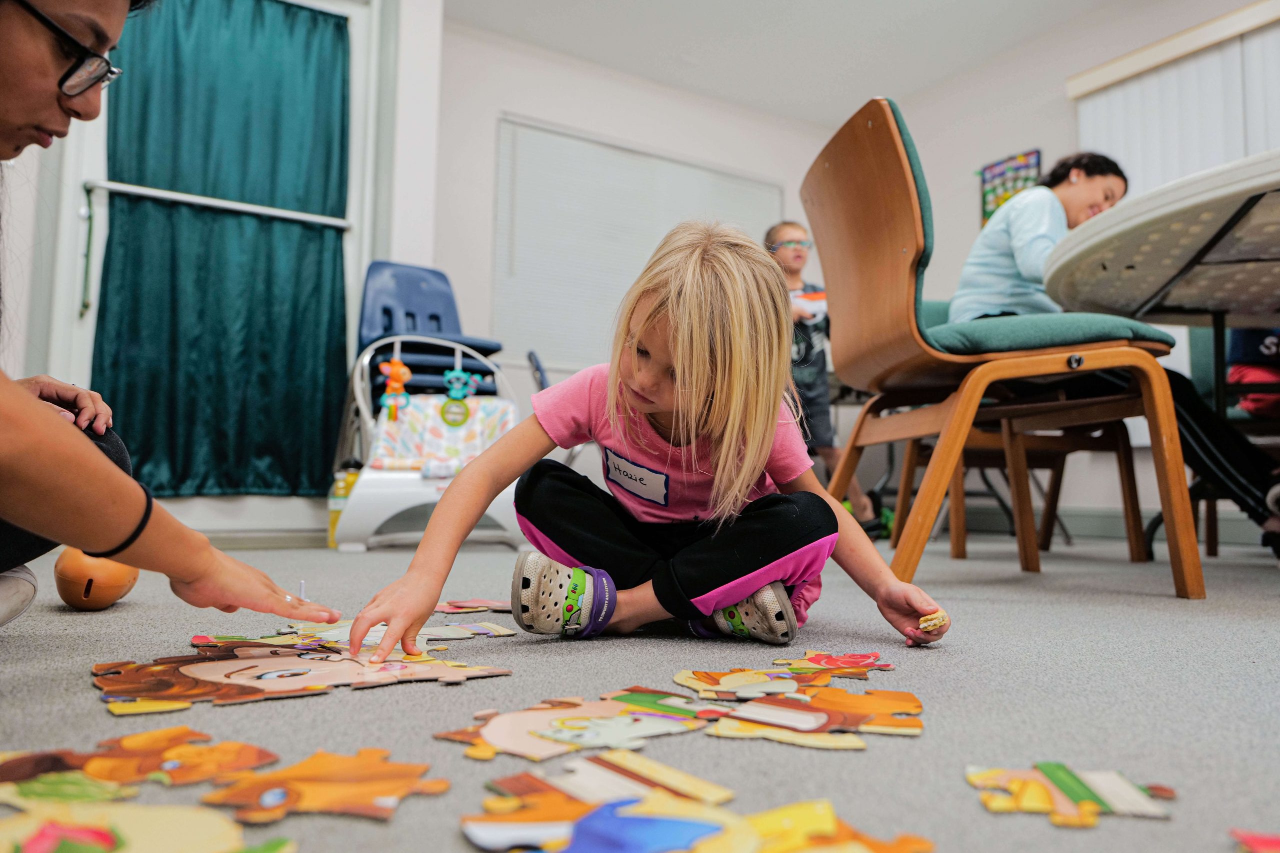 Girls plays with toys on floor