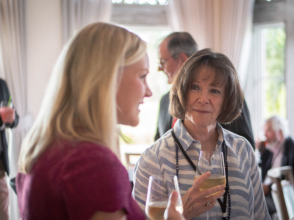 Better Together CEO Megan talks with a supporter at the Naples reception
