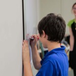 Child draws on a whiteboard