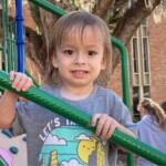 Child on playground looks into camera
