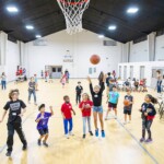 Children play basketball in a church gymnasium